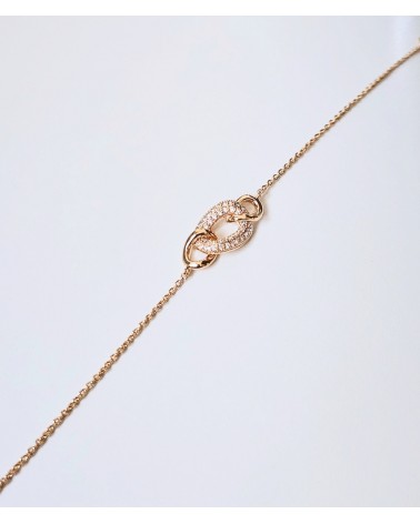 Bracelet en plaqué or avec trois maillons ovales entrelacés dont un avec oxyde de zirconium