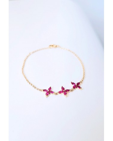 Bracelet en plaqué or et trio de fleurs en verre couleur fuchsia
