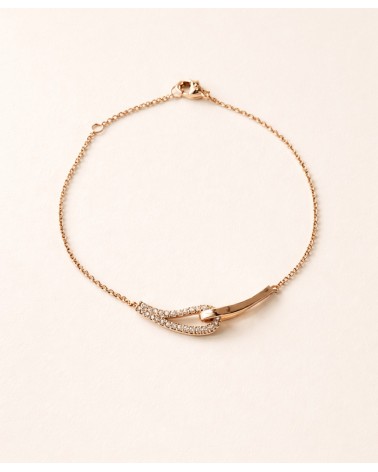 Bracelet forme double goutte en plaqué or, l'une lisse, l'autre sertie d'oxydes de zirconium