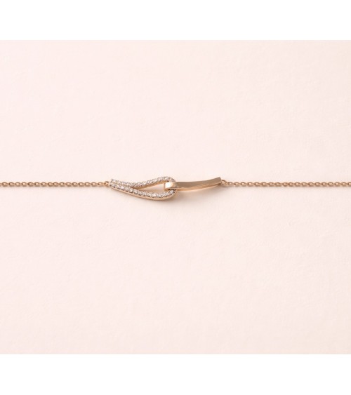 Bracelet forme double goutte en plaqué or, l'une lisse, l'autre sertie d'oxydes de zirconium