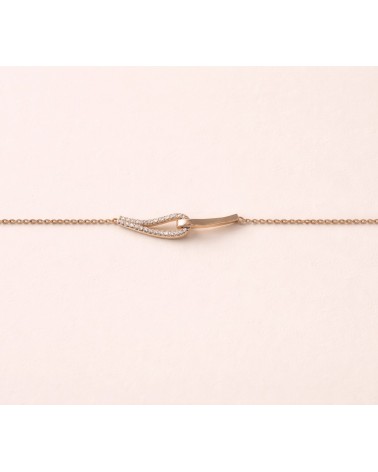 Bracelet forme double goutte en plaqué or, l'une lisse, l'autre sertie d'oxydes de zirconium